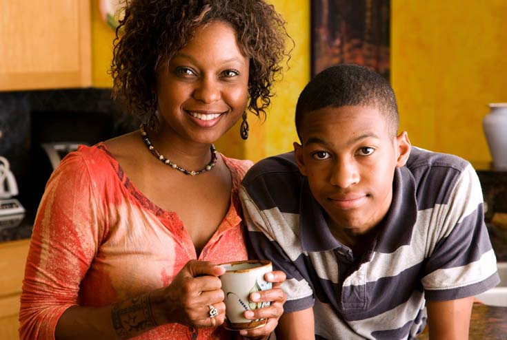 Woman with teenage boy in kitchen