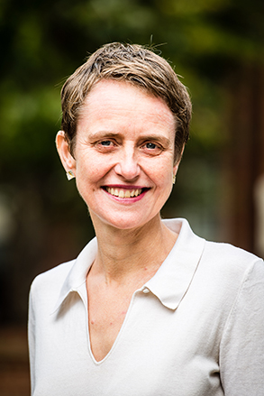 Maxine Holdsworth wearing a white blouse and looking at the camera smiling