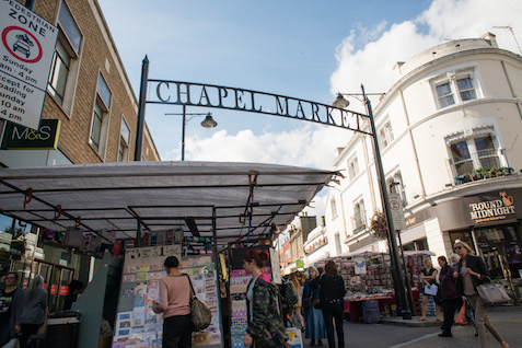 Islington Chapel market on a sunny day with people  browsing the stalls