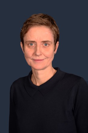 Maxine Holdsworth, Corporate Director of Housing, wearing a navy blue blouse and looking directly at the camera and smiling for a portrait photograph