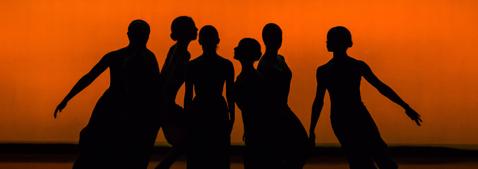 silhouettes of dancers on an orange background 