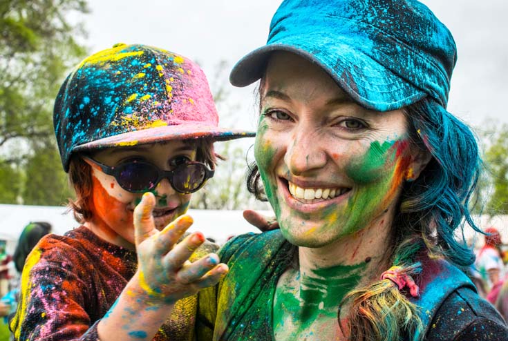 Young woman and young boy covered in paint